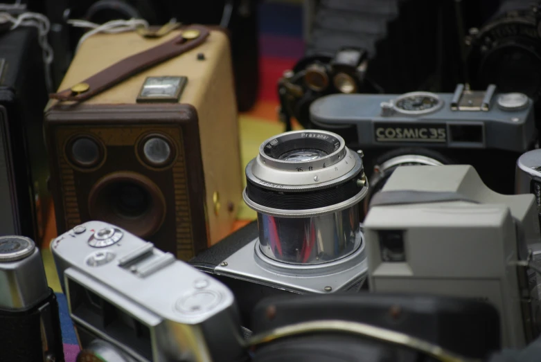 an old camera and other vintage cameras on display