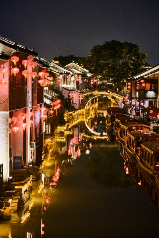 night time in a chinese city with lit lanterns hanging