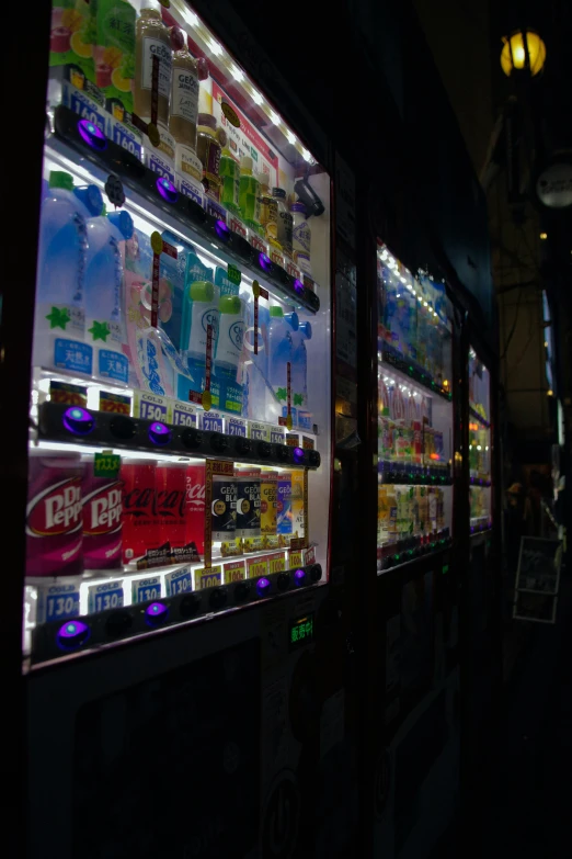 some type of vending machine lit up at night