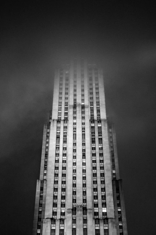 a tall building with many windows at night