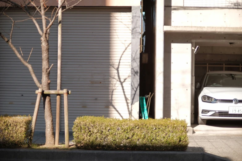 a car parked by a garage with an entrance