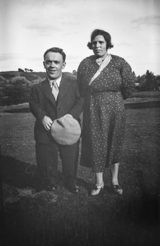 a man and a woman are posing for the camera
