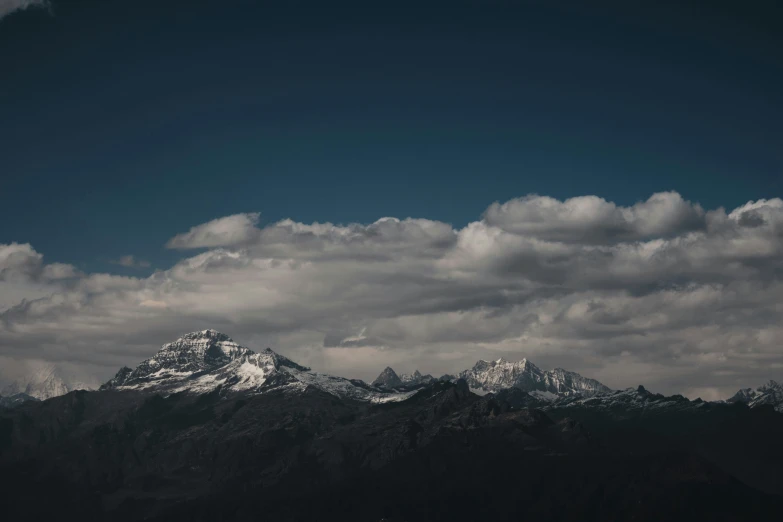 mountains with clouds in the sky above