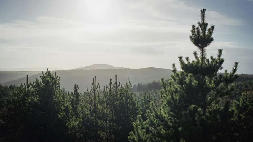 an almost - cloudy day on the hills with mountains in the distance