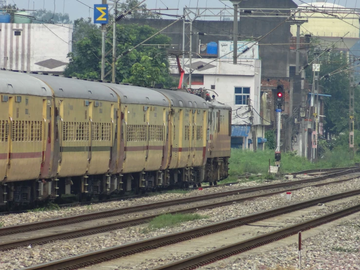 a train traveling down tracks near tall buildings