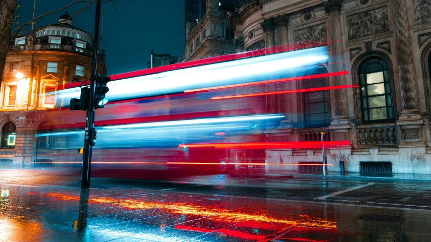 a red double decker bus in the city