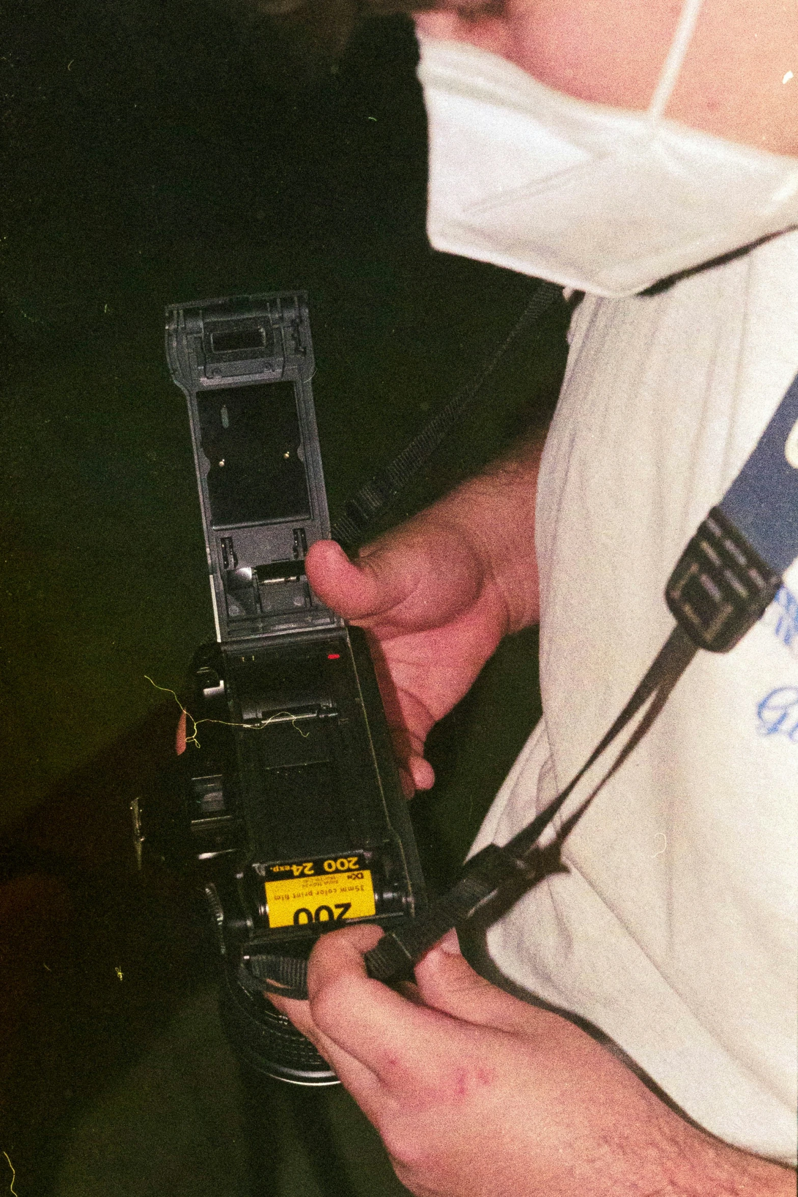 a man holding a piece of equipment and a cellphone