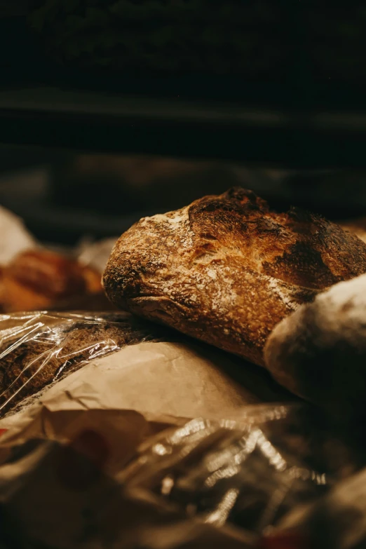 bread and other breads sit in a pan covered in foil