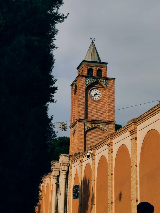 a church with a clock tower against a cloudy sky