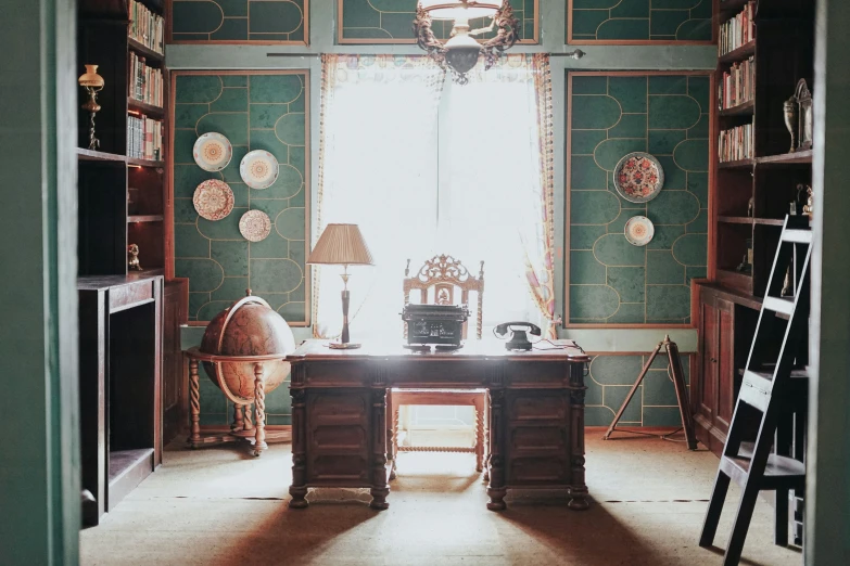 a desk in an office with shelves and bookshelves