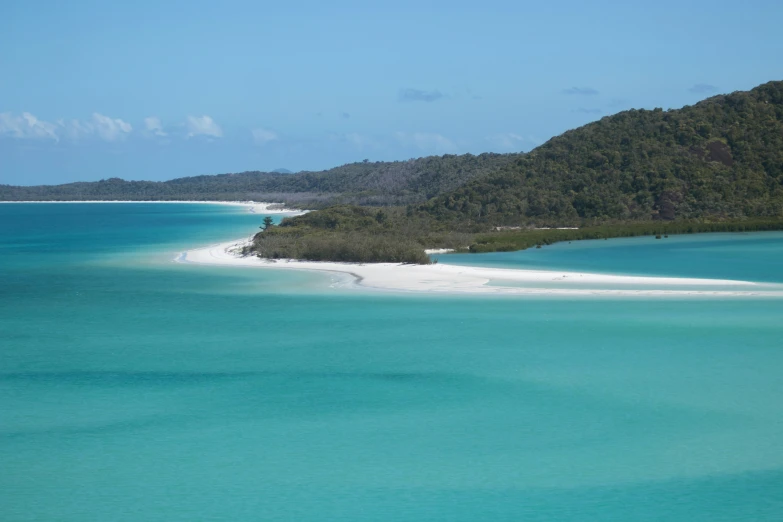 an island with a white sand beach and some trees