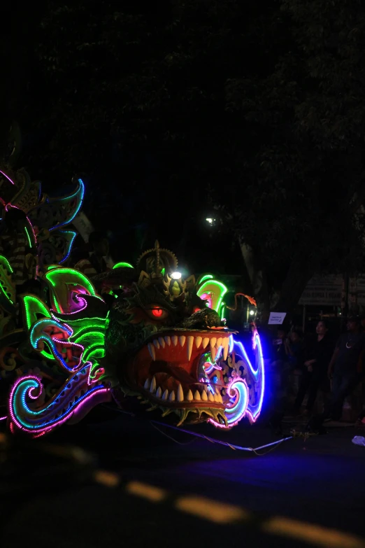 a group of people at night on parade with many lights