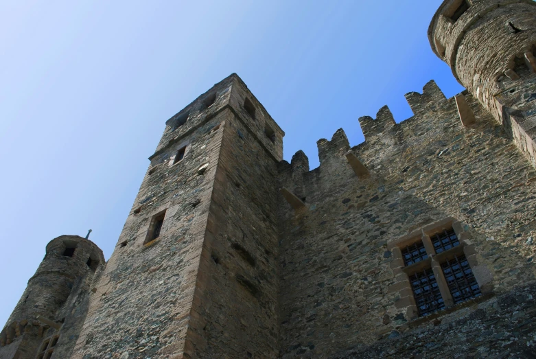 an old brick castle with two large windows