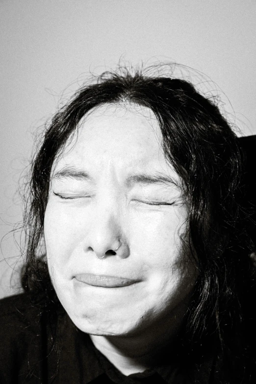 black and white pograph of woman smiling in black shirt