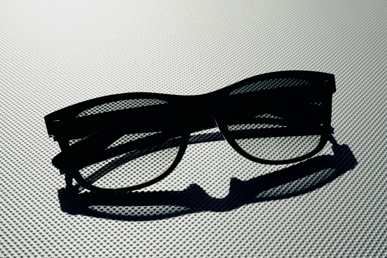 shadow of a pair of glasses on white paper