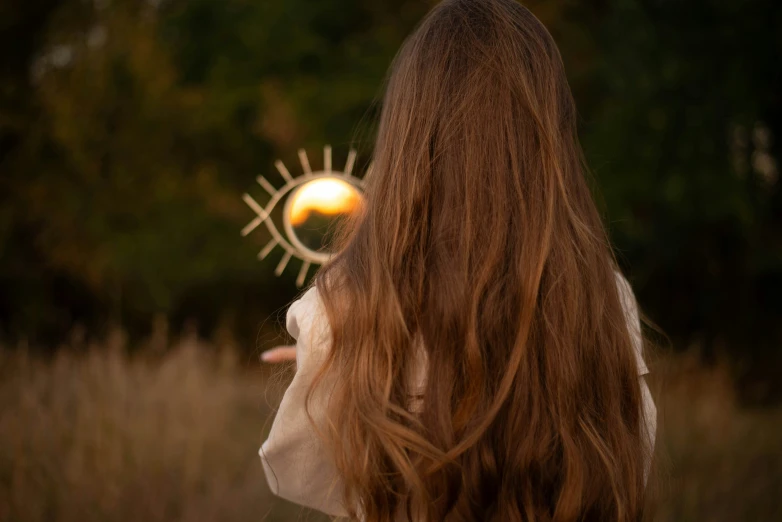 a girl holding an orange frisbee in her hand