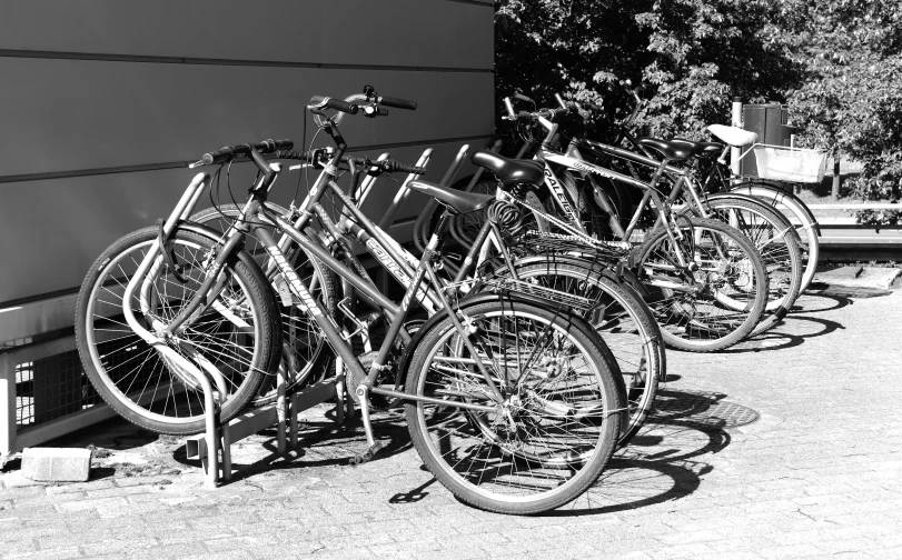 many different bikes lined up near the wall