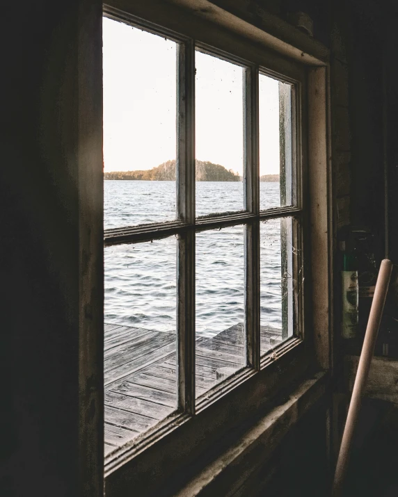 an empty window overlooks the water and island