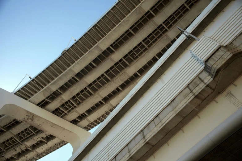 the underside of two large buildings are shown from below