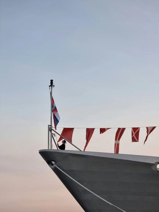 a huge boat is seen with flags in the air