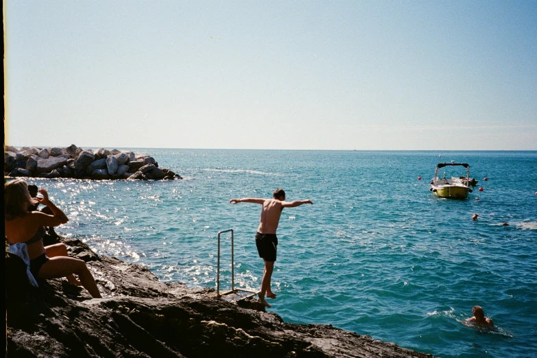 a man standing on the beach next to an ocean