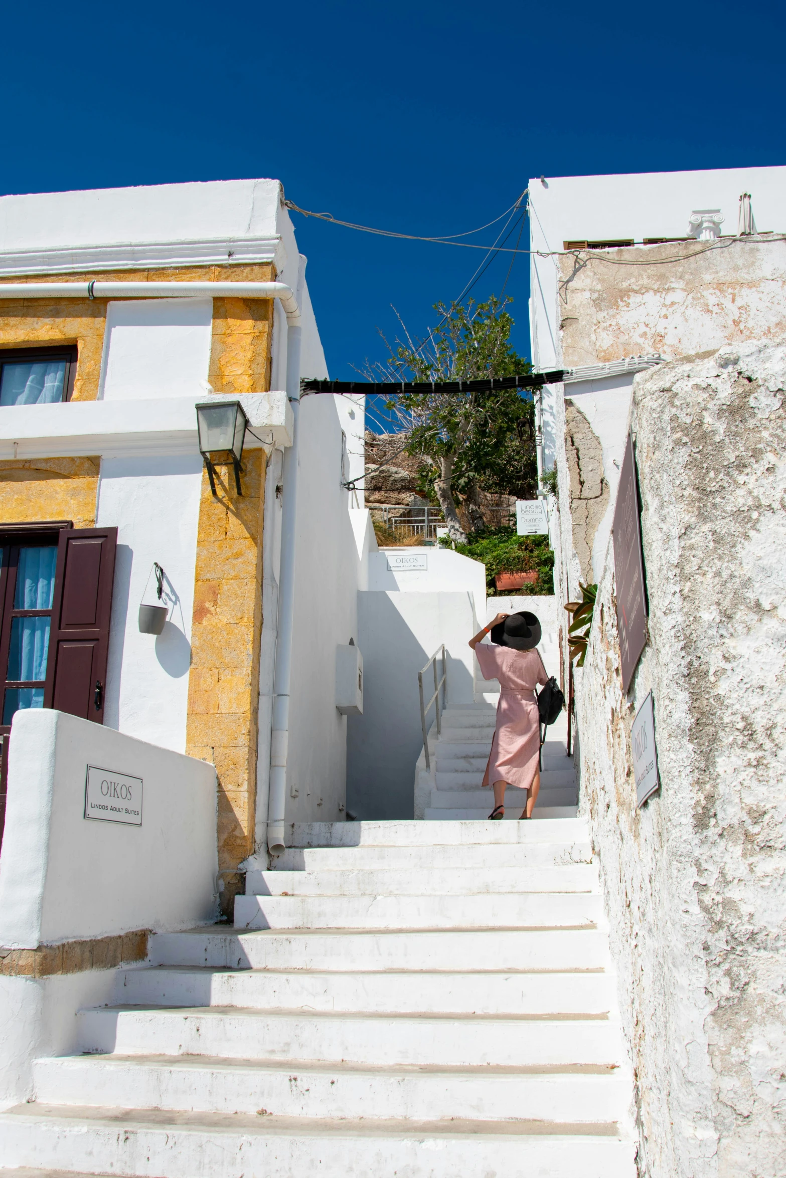 a woman is on the stairs of some town