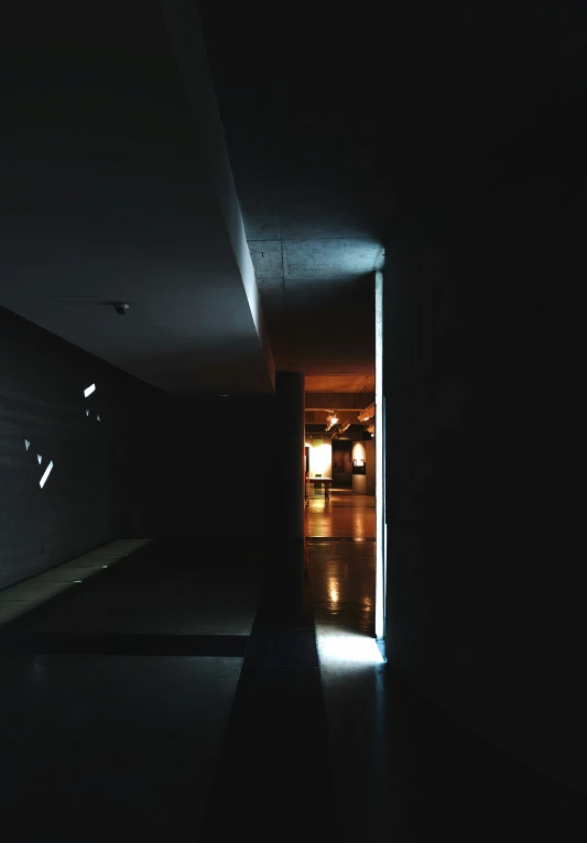 this is a dark hallway with a light coming in