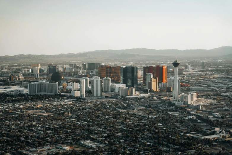 an aerial view of a city with mountains in the background