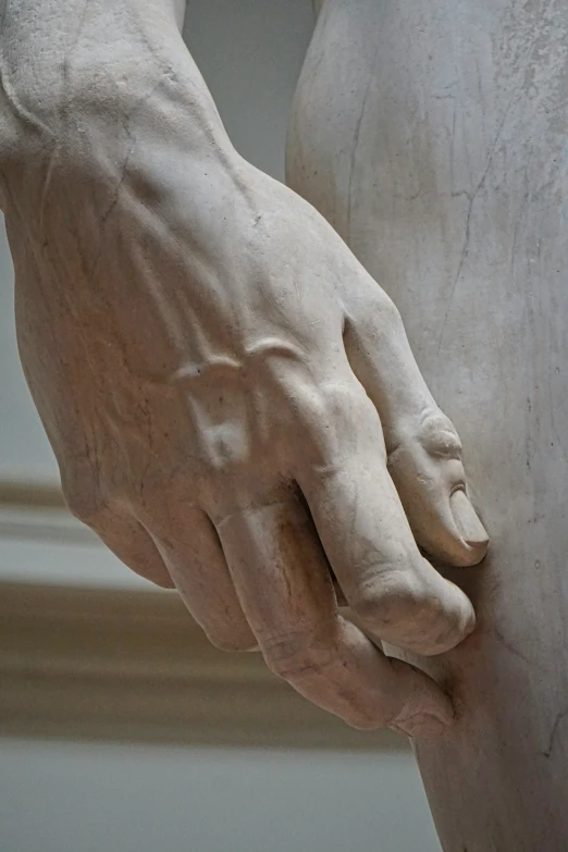 a close up view of the hand and foot of a statue