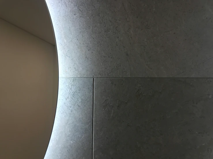 grey abstract architecture with gray walls, curved doorway, and small square window