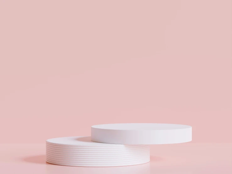 two white round dishes sitting on top of each other