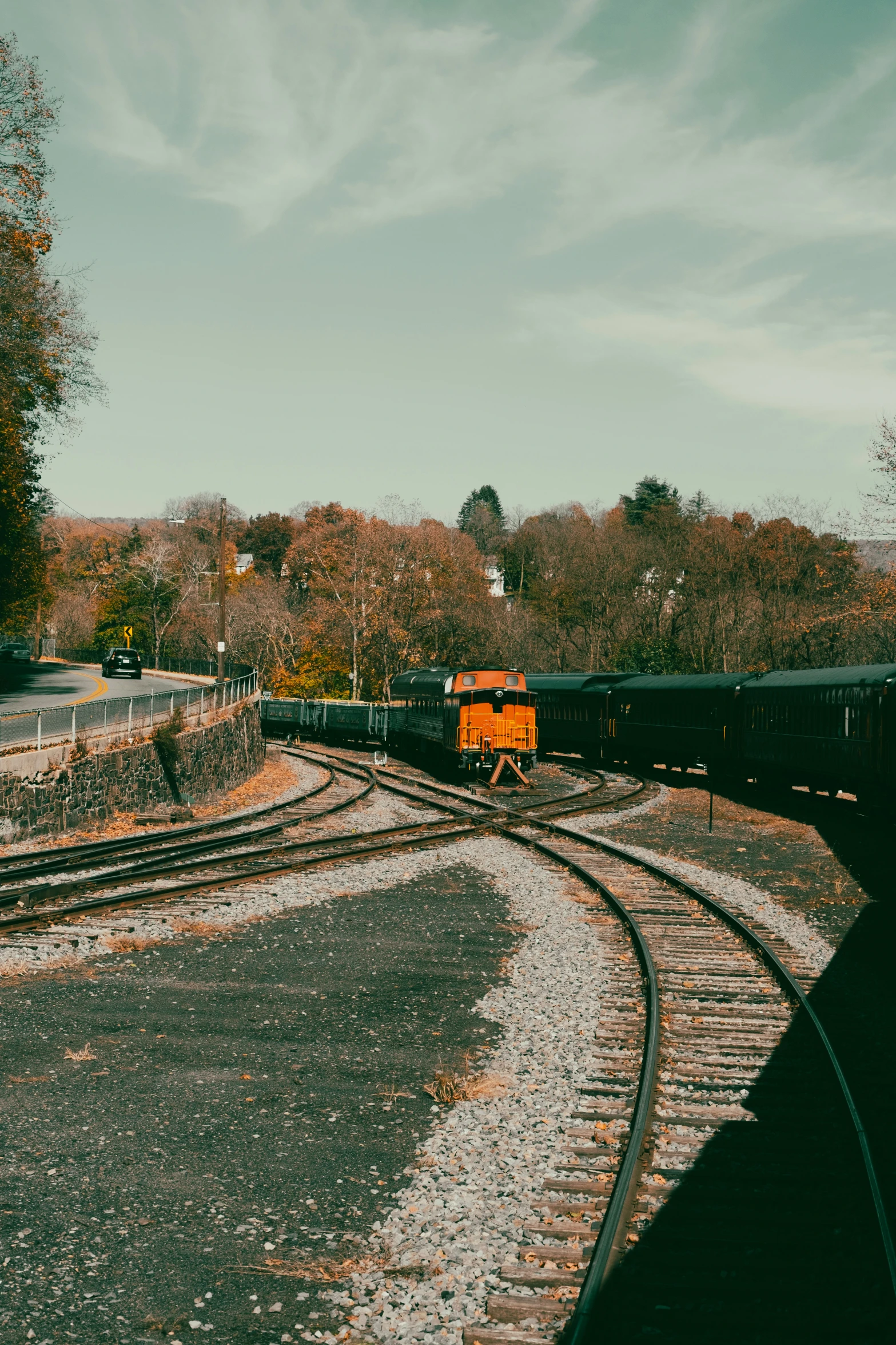 a train is traveling down the tracks near a field