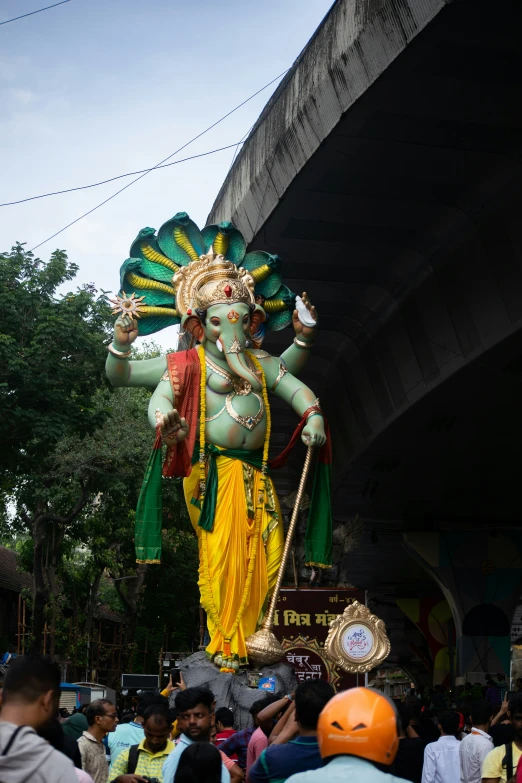 a statue of an indian god appears to be holding a staff