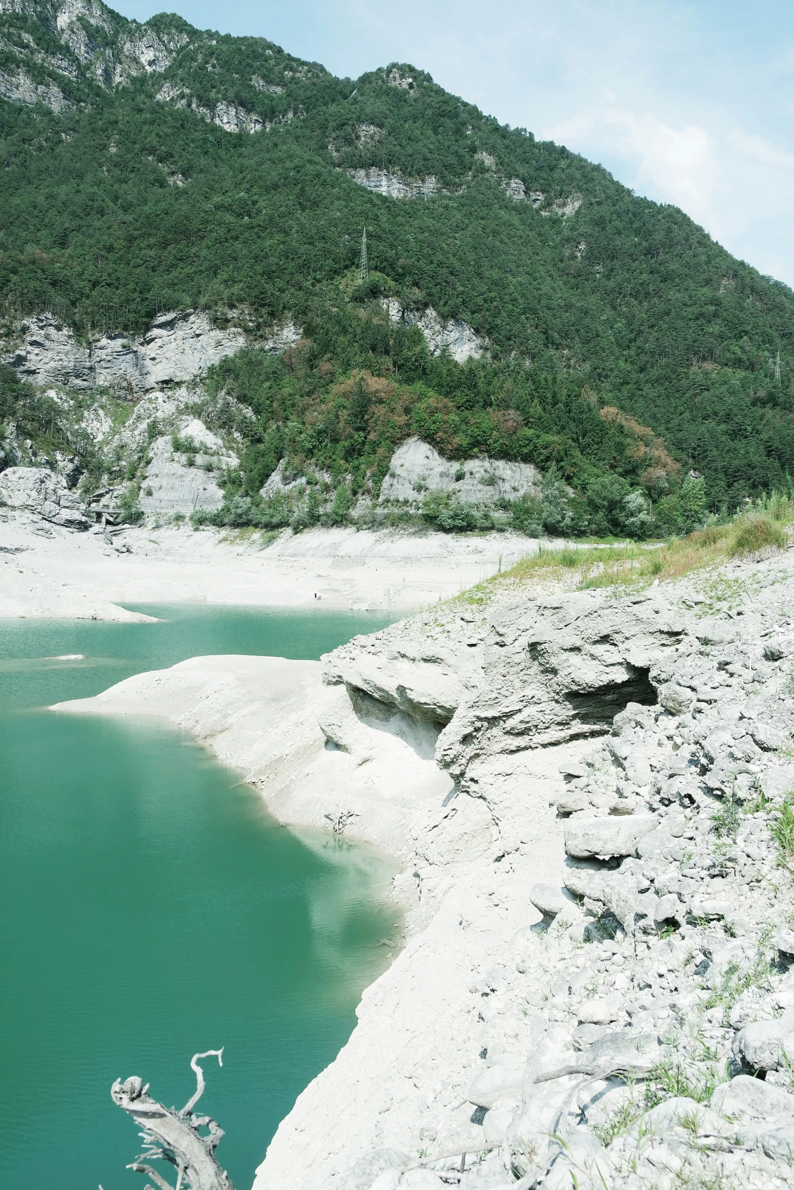 some water a mountain and rocks and trees