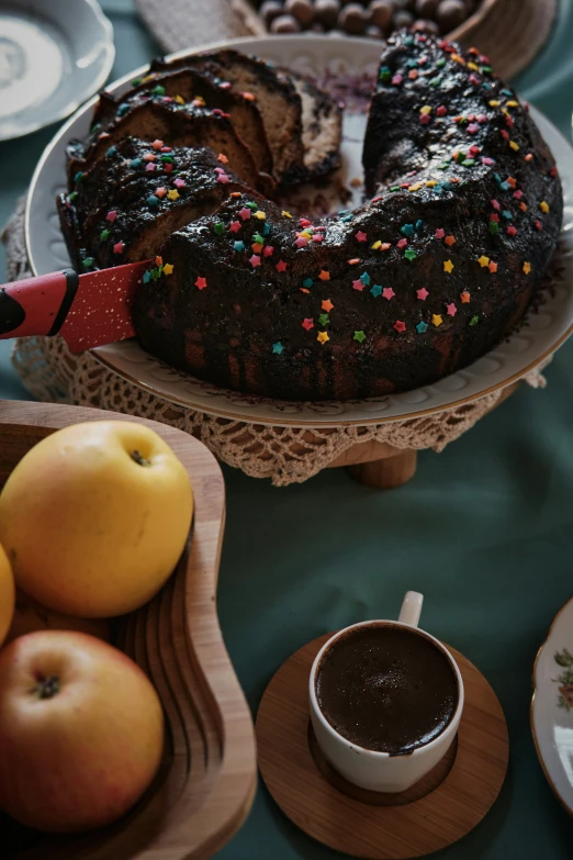 chocolate cake on top of the table with other desserts and beverages