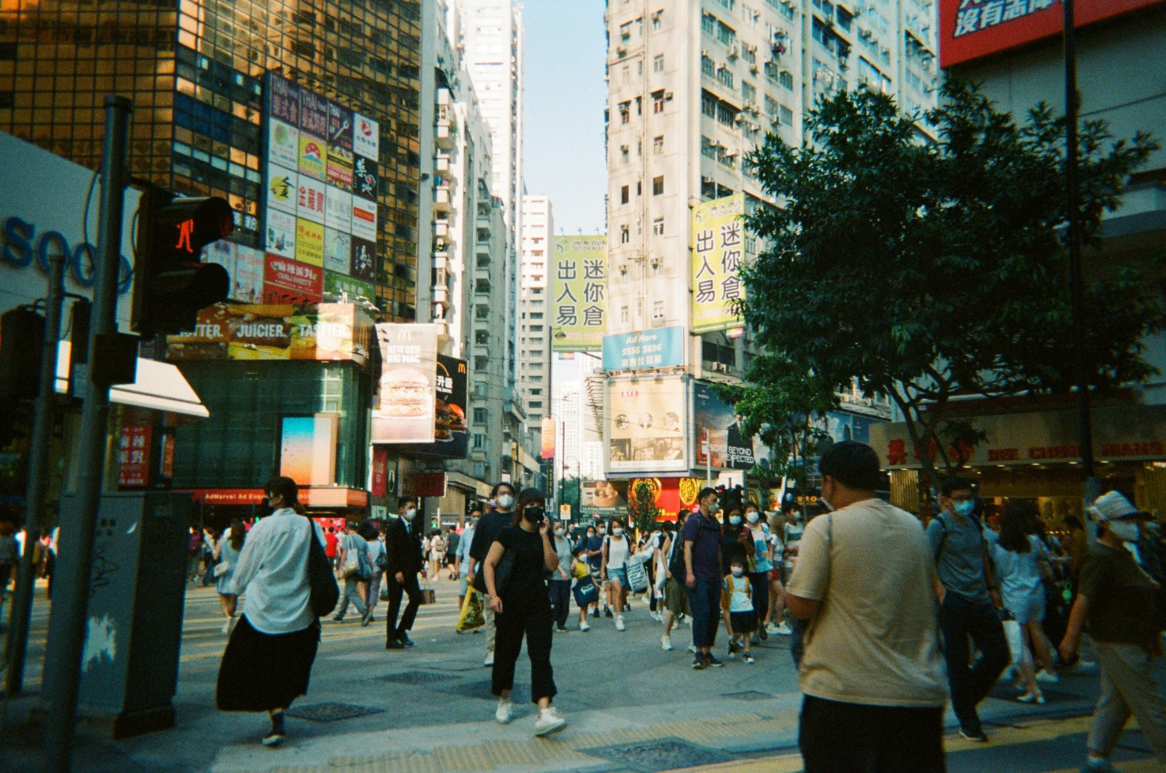 busy street with people crossing and pedestrian crossing