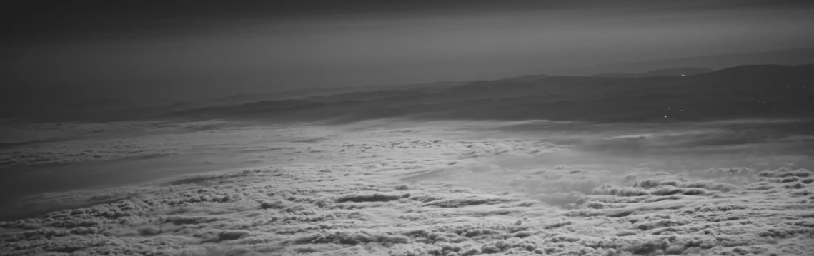 the clouds over the mountains are dark