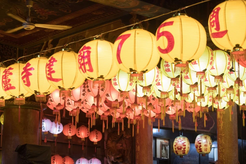 an array of lanterns hanging in a building