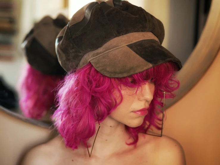 a mannequin is wearing a hat with pink hair