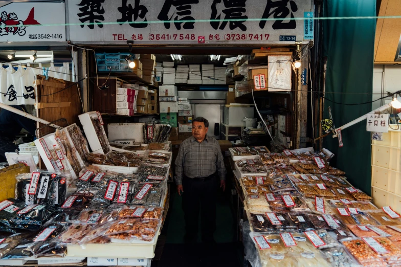 a man standing in the door way to a fish market