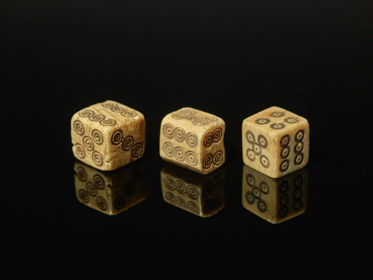 two wooden dice sitting side by side on top of a table