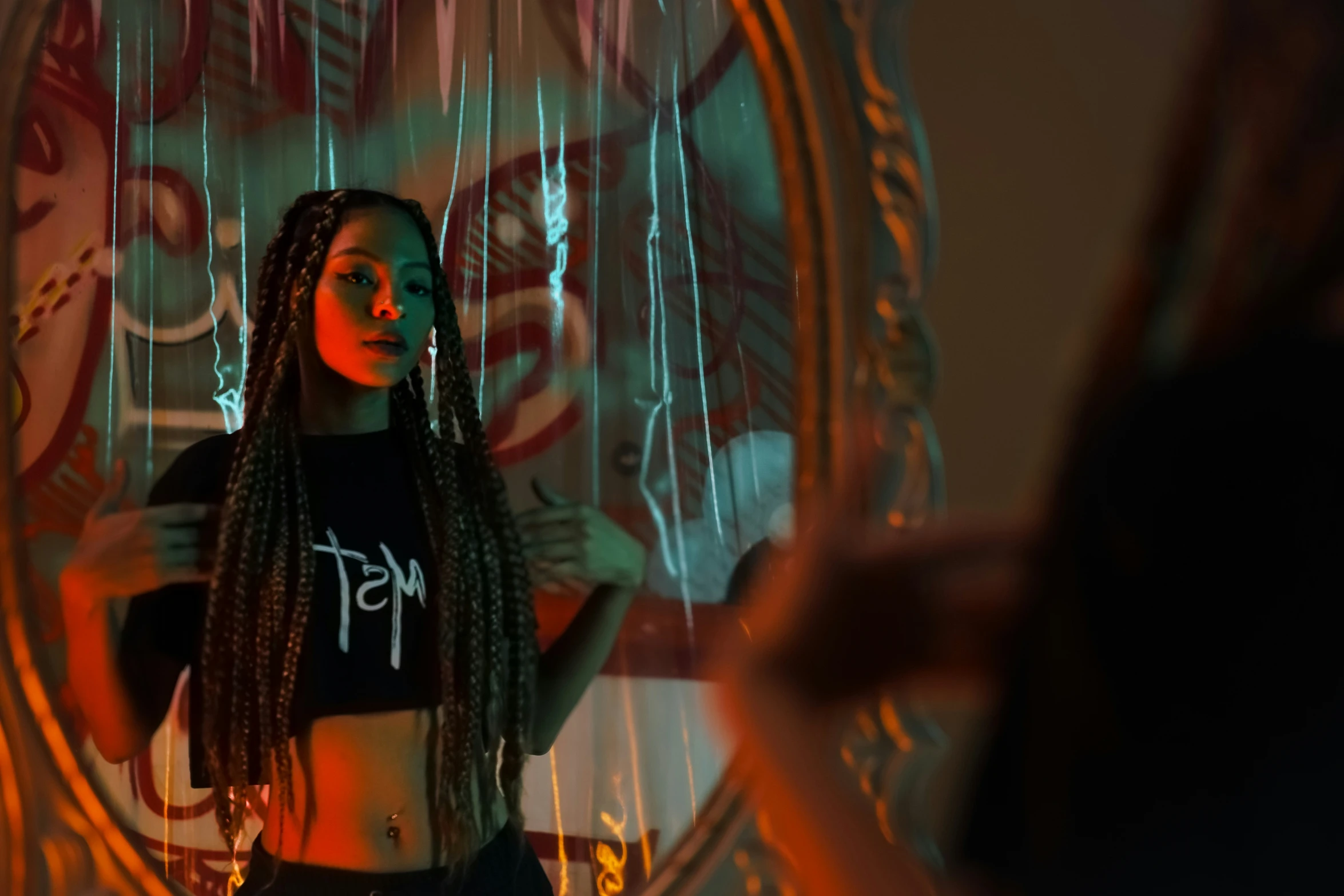 a woman standing in front of a mirror with her hair in the air