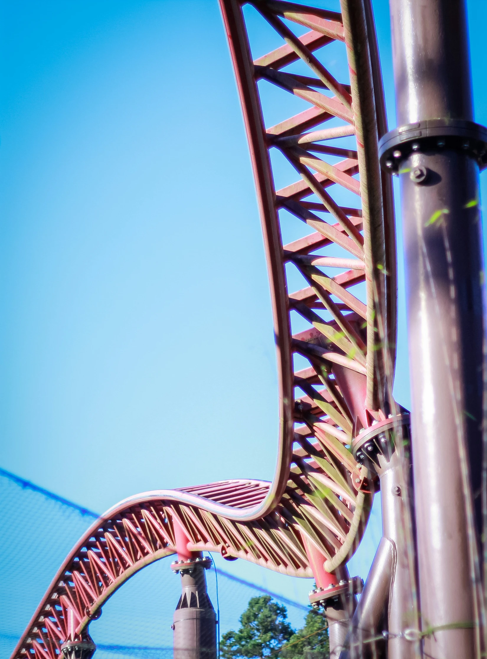 the top of the tower is red and there is a long walkway up in the side of it