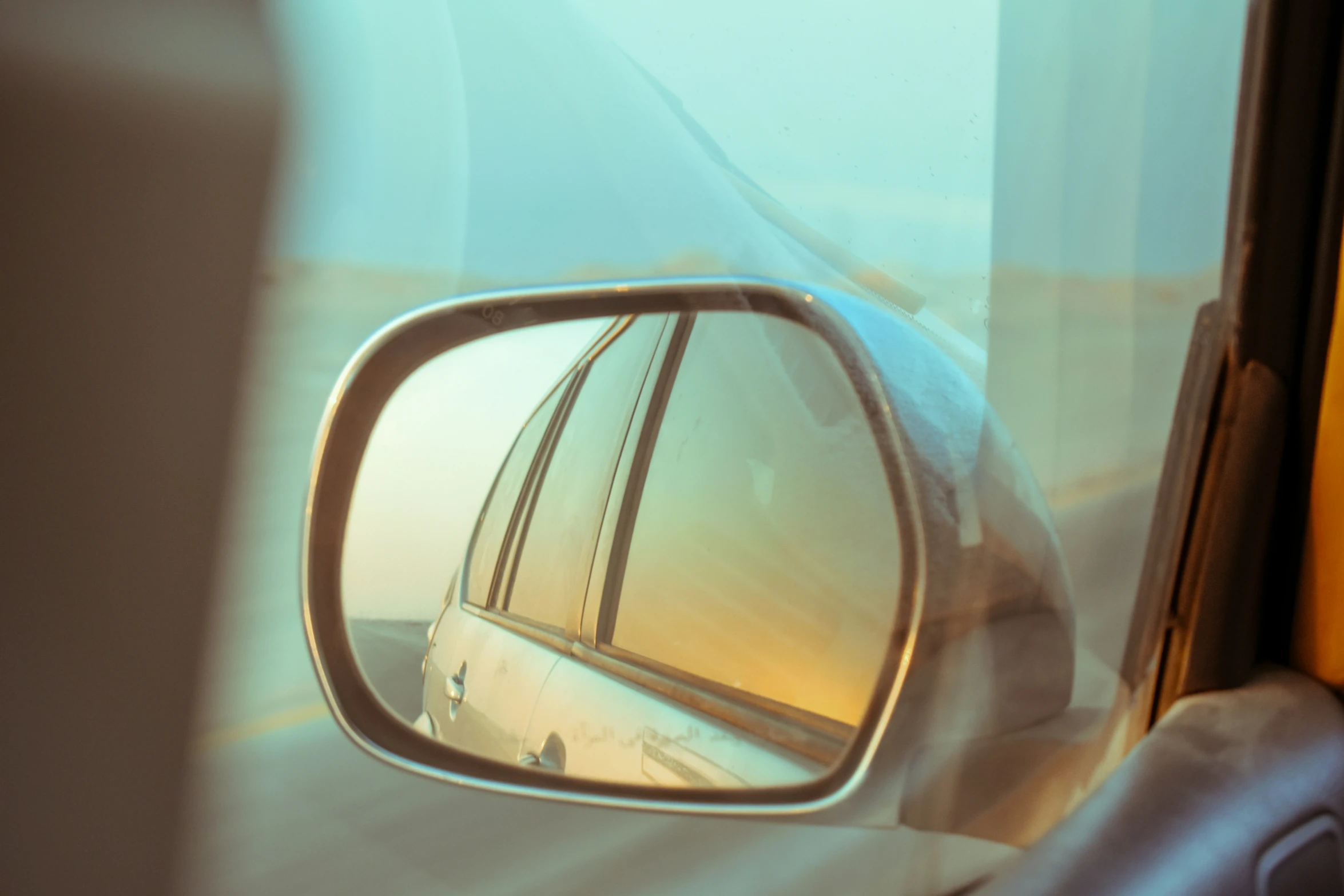 a view of the wing mirror of a car