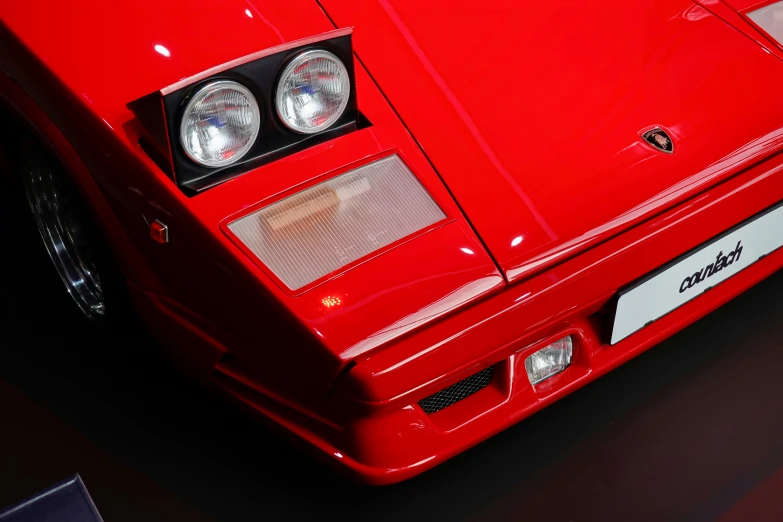 a red ferrari car is shown with lights on