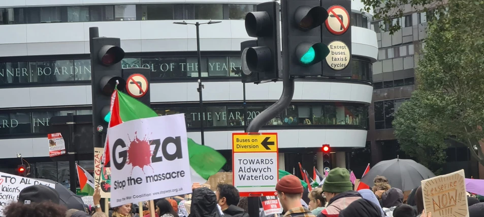 there are several people holding signs outside