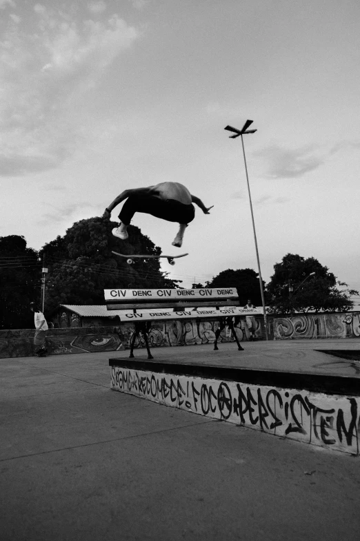 a man doing a skateboarding trick in a black and white po