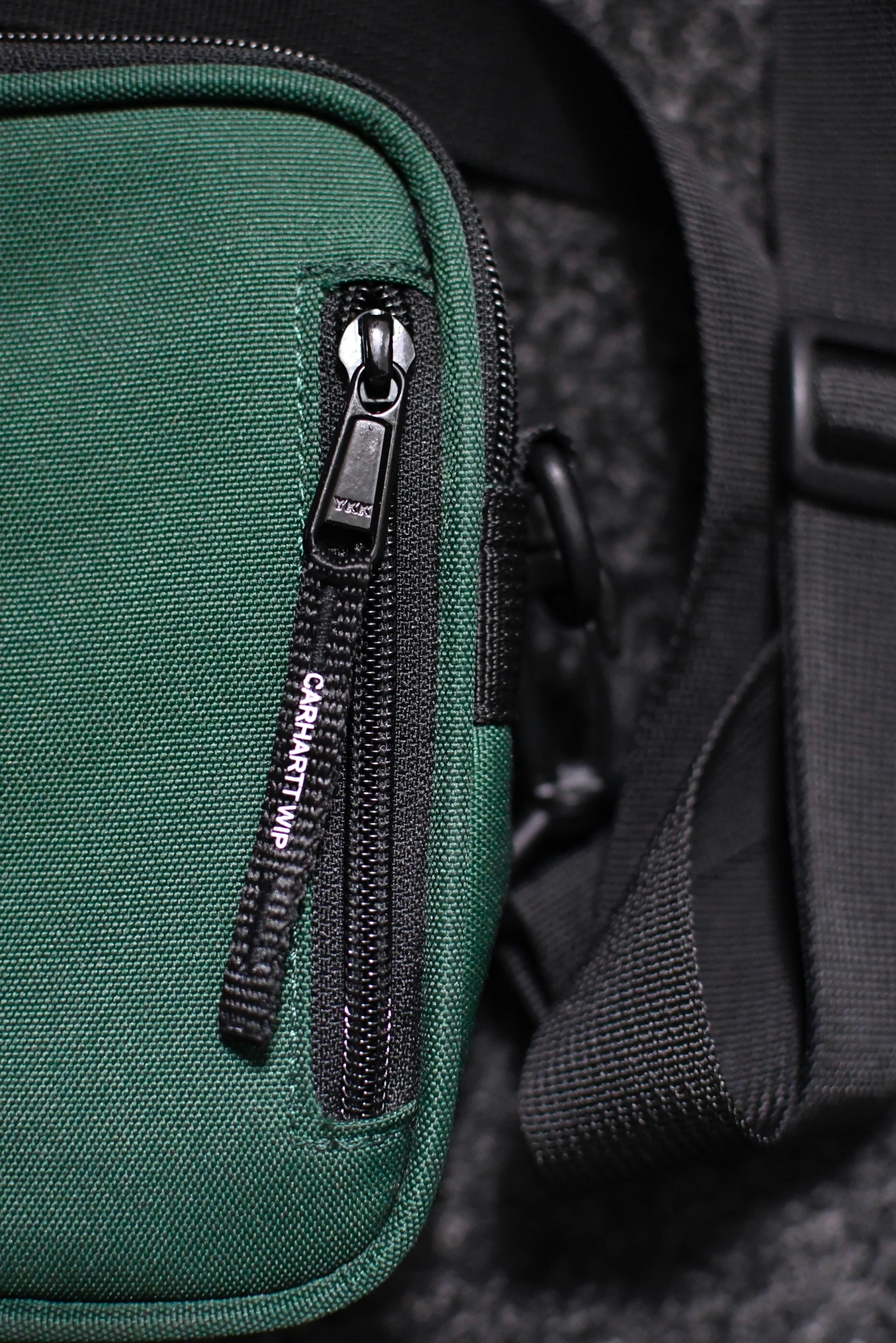 there is a zipper in the bottom of a green bag