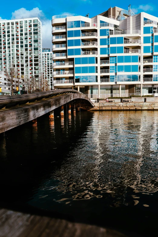 some buildings on a river and bridge crossing