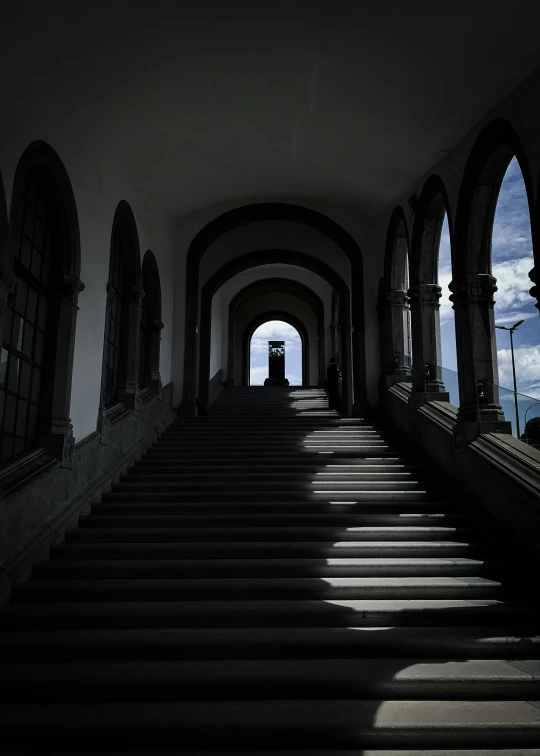 a dark alley with many windows and a clock